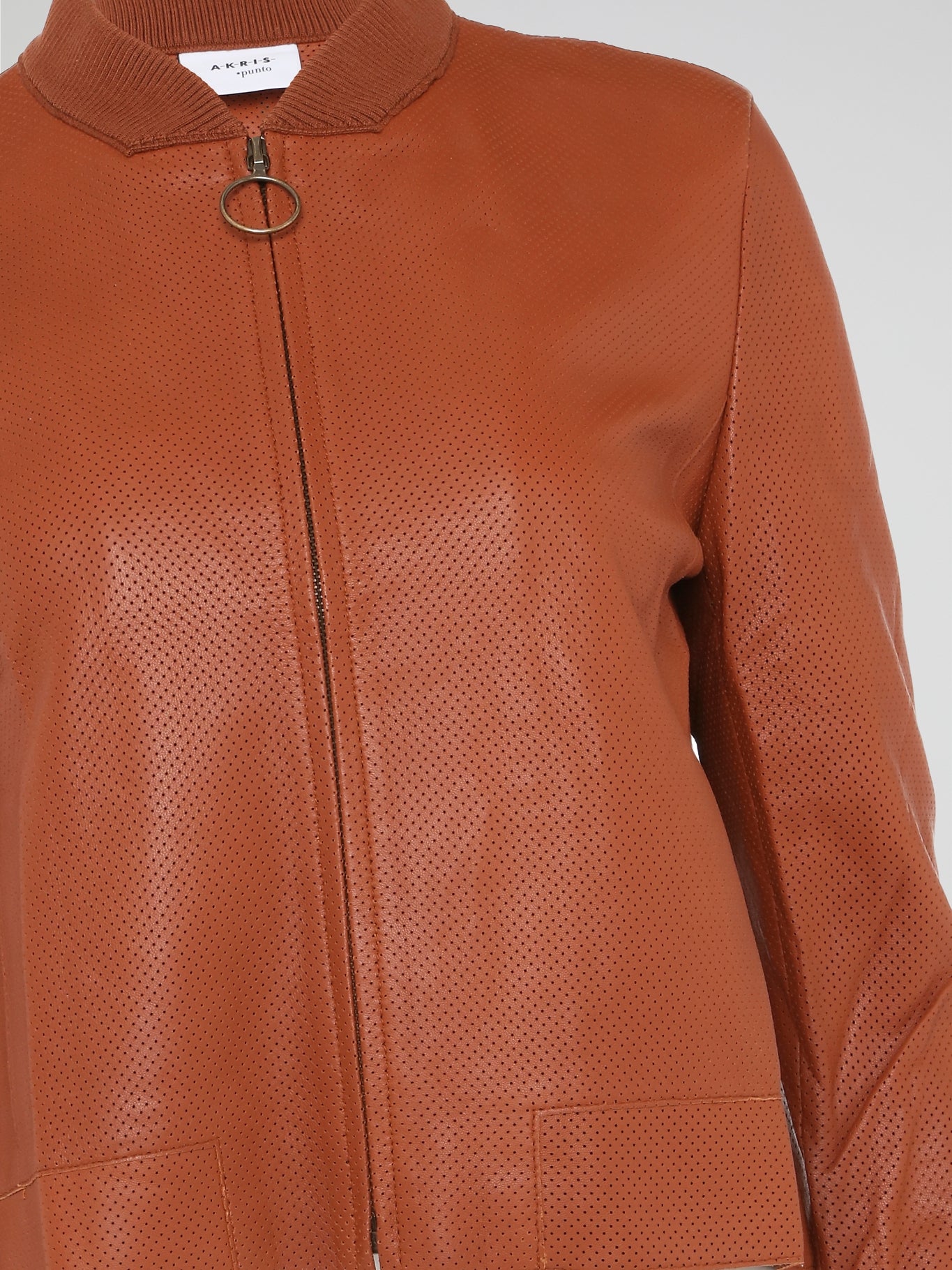 Step into the world of effortlessly cool style with our Orange Perforated Bomber Jacket by Akris Punto. Crafted with meticulous attention to detail, this vibrant piece seamlessly blends the classic bomber silhouette with modern perforated fabric for a unique twist. Whether you're exploring the city or hitting the dance floor, make a bold statement and exude confidence with this must-have jacket.