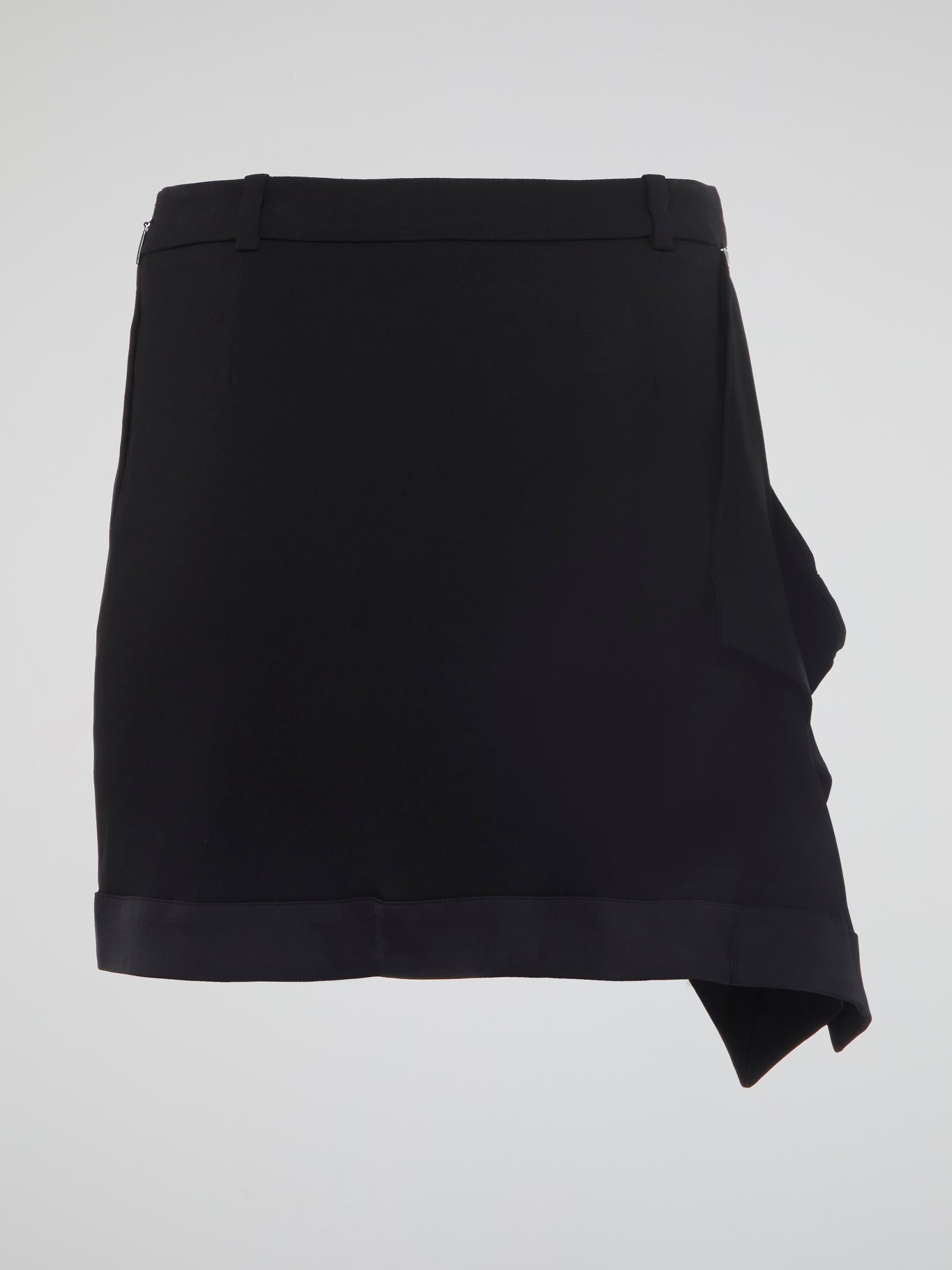 Dive into a world of bold, edgy style with our Black Asymmetrical Mini Skirt by Roberto Cavalli. This statement piece is perfect for the fashion-forward individual who is unapologetically confident in their unique sense of style. Stand out from the crowd and make a fierce statement with this must-have wardrobe staple.