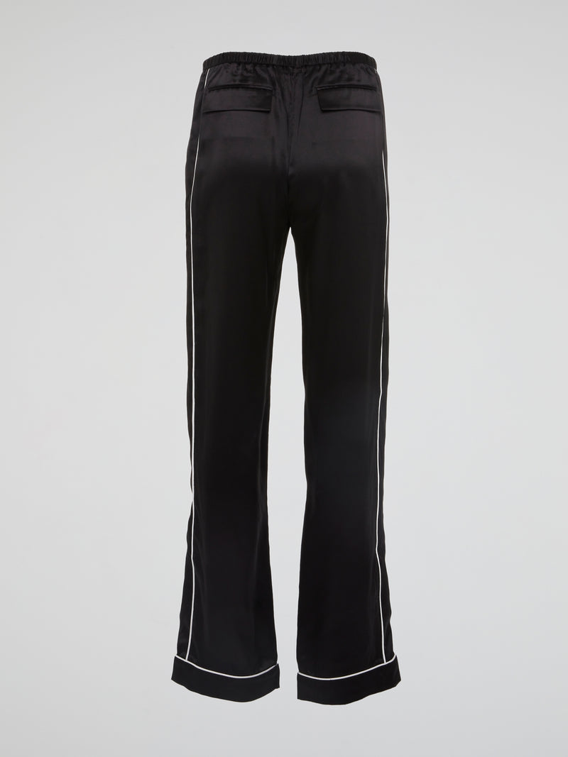 Feel bold and sophisticated in these Black Contrast Lining Flared Pants by Roberto Cavalli. The sleek silhouette and dramatic flared legs effortlessly elevate any outfit, making you stand out in a crowd. Embrace your fashion-forward style and turn heads wherever you go with these statement-making pants.