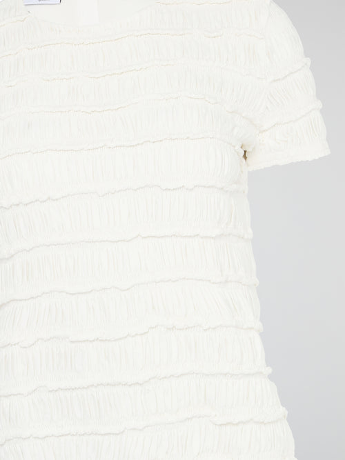 The White Tiered Top from Akris Punto is a captivating blend of sophistication and whimsy. With its unique tiered design, this versatile top adds a playful twist to any outfit. Made from premium materials, it effortlessly drapes to flatter your figure and is perfect for both casual and formal occasions.