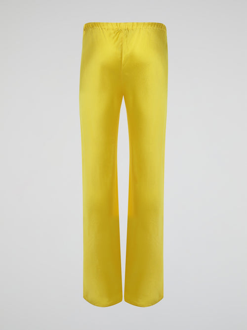 Step up your style game with these vibrant Yellow Drawstring Silk Trousers by Roberto Cavalli. Crafted from luxurious silk, these statement trousers offer a silky soft touch and a flowing silhouette that is both elegant and comfortable. Perfect for any occasion, let these eye-catching pants be the star of your ensemble.